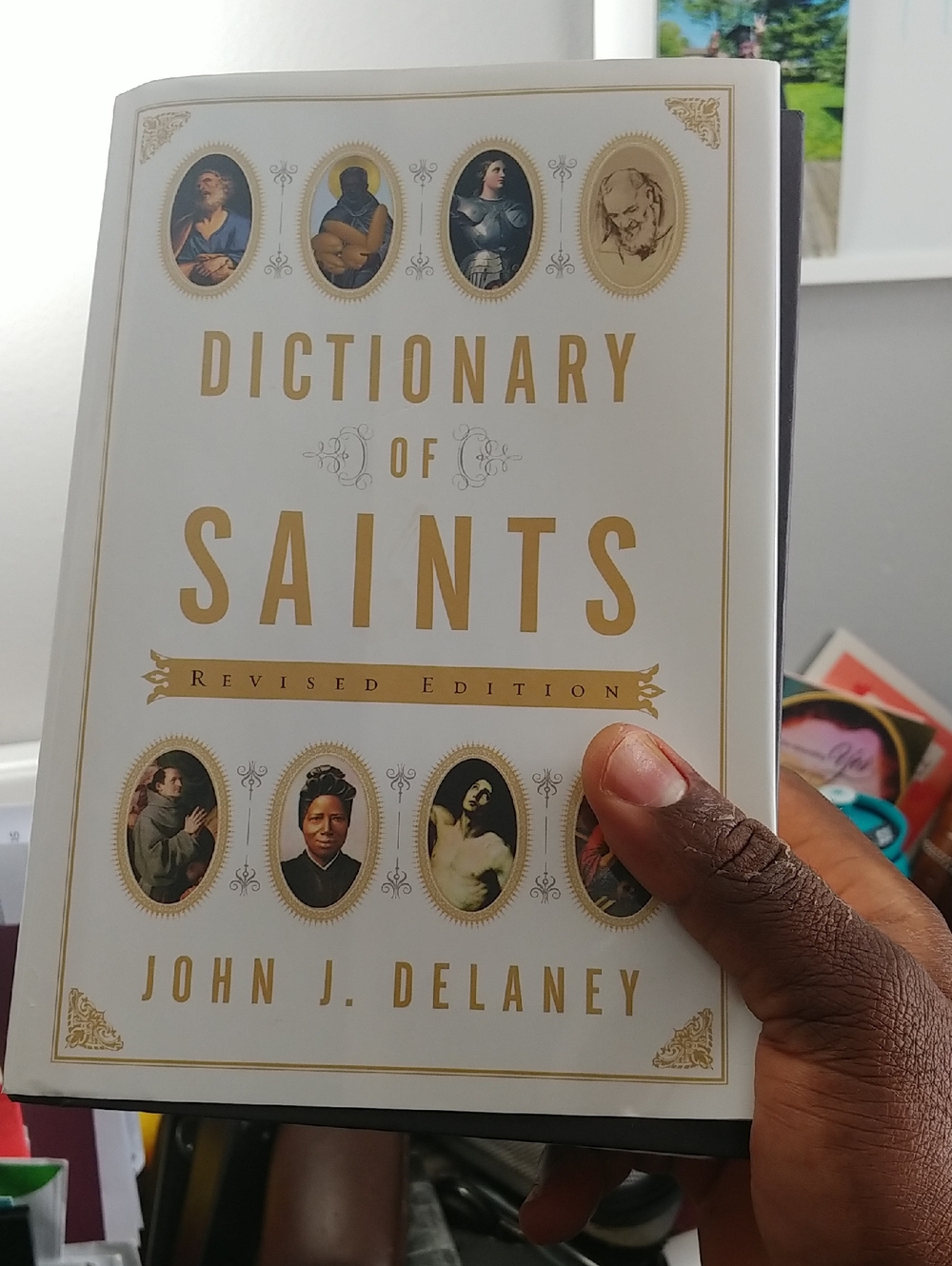 Dictionary of Saints by John J. Delaney — White and Gold Cover